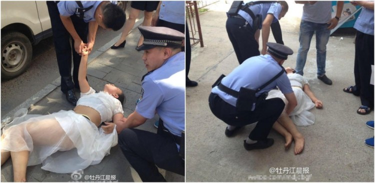 Polisi mengevakuasi wanita di Mudanjiang, China yang coba bunuh diri